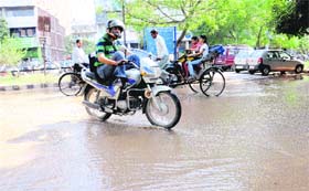 The view of a waterlogged road after a water pipe burst at the Sector-34 market in Chandigarh on Monday.