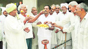 Farmers celebrate after the Allahabad High Court order in Noida on Friday. 