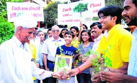 Students of Gurukul Vidyapeeth distribute saplings to senior citizens during the Green Diwali campaign in Chandigarh on Monday