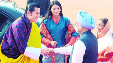 Bhutans King Jigme Khesar Namgyel Wangchuck shakes hands with Prime Minister Manmohan Singh as President Pratibha Patil and Bhutan's Queen Jetsun Pema Wangchuck look on at the presidential palace in New Delhi on Monday. The King and Queen are on a nine-day state visit, their first foreign trip after marriage. They will leave for Rajasthan on Tuesday.