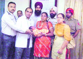 Doctors hand over the abandoned baby to officials of the Swami Gangagiri Bhuriwale International Foundation Dham at Talwandi Khurd on Tuesday