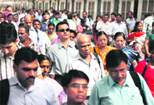Commuters make their way on the Churchgate railway station platform in Mumbai during morning rush hours on Monday. 