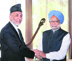 Prime Minister Manmohan Singh with Afghan President Hamid Karzai in Addu on Friday.