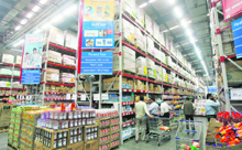 Customers shop at a store, which is a joint venture of Wal-Mart Stores Inc and Bharti Enterprises, at Zirakpur near Chandigarh.