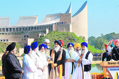 Akal Takht Jathedar Giani Gurbachan Singh presents a sword to Punjab Chief Minister Parkash Singh Badal on Friday during the inaugural ceremony of the Khalsa Heritage Memorial, a museum on Sikhism, located on a 75-acre site in the holy city of Anandpur Sahib in Punjab. 