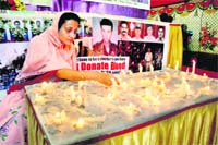 AN EARNEST HOMAGE: A woman lights candles to pay tributes to the victims of the 26/11 terror attack at the CST railway station in Mumbai on Saturday