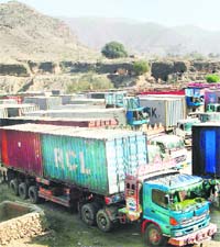 Trucks carrying supplies for NATO forces in Afghanistan are seen parked at the Pakistan's Torkham border