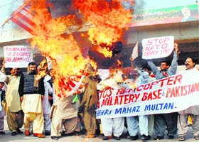 Protesters burn a US flag in Multan against a NATO strike on Pakistan troops on Sunday