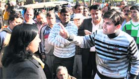 Ward 2 candidates Saurabh Joshi and Anu Chatrath argue at the market in Sector 15 of Chandigarh on Saturday