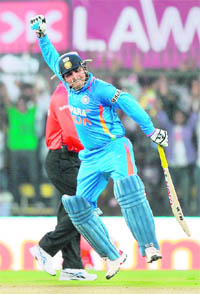 Virender Sehwag celebrates after his feat against the wIndies in indore on Thursday