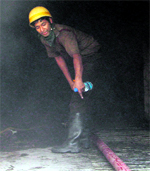 A firefighter battles flames at AMRI Hospital.