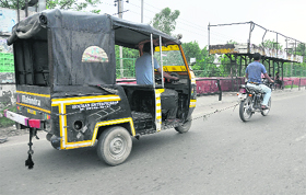 A motocyclist tows away a broken down auto-rickshaw with the help of a rope on the GT Road in Ludhiana on Sunday.