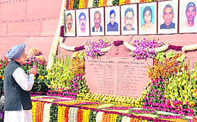 Prime Minister Manmohan Singh pays tributes to the martyrs on the 10th anniversary of the attack on Parliament in New Delhi on Tuesday.