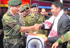 Longsidar Senar, chairman of Karbi militants outfit United Peoples Democratic Solidarity (UPDS), shakes hands with an Army officer while giving up arms. 