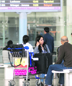 Passengers wait at Terminal 1D of the Indira Gandhi Airport in New Delhi on Monday.