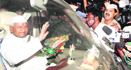 Anna Hazare waves towards his followers in Navi Mumbai on Monday.