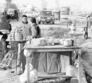 Fruit-sellers occupy space along the Chandigarh-Ambala highway at Zirakpur on Friday.