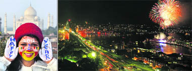 (L) A tourist welcomes New Year in Agra; fireworks over Sydney Harbour set the tempo for celebrations. 