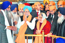 Prime Minister Manmohan Singh and his wife Gursharan Kaur pay obeisance at the Golden Temple in Amritsar on Sunday.