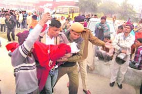 A parent rushes his injured child to Civil Hospital, Ambala Cantt after the accident