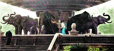 Workers cover statues of elephants, the BSP symbol, at the Samajik Parivartan Pratik Sthal at Gomti Nagar in Lucknow on Sunday in compliance with Election Commission orders. 