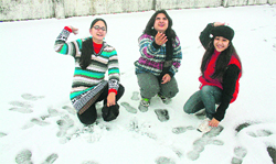 Girls playing in hailstones in Johri village, near Dehradun