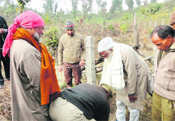 Environmentalist Sunderlal Bahuguna plants a sapling on his 86th birthday in Shuklapur village near Dehradun 