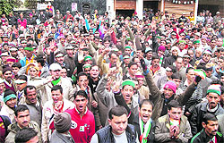 Congress supporters raise slogans in support of the party candidate from Dhanaulti at Nainbagh on Saturday