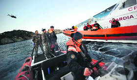 Coast Guard boats patrol near cruise ship Costa Concordia after it ran aground off the Tuscan coast in Italy.