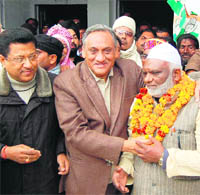 Hussain Ahmed, senior Samajwadi Party leader, being greeted by Vijay Bahuguna, Congress MP from Tehri, in Dehradun on Wednesday.