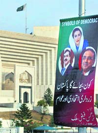 A poster of Pakistan Prez Asif Ali Zardari, PM Yousuf Raza Gilani and late leader Benazir Bhutto in front of the SC in Islamabad