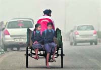 Schoolchildren brave the chill in New Delhi on Wednesday