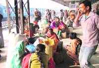 GETTING BUSY: Migrant labourers at the Ludhiana railway station