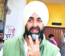 Manpreet Badal flashes a victory sign after voting