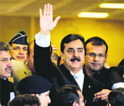 Pak PM Yousuf Raza Gilani waves upon his arrival at the Supreme Court for a hearing . 