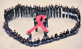 Students of Government Model Senior Secondary School Sector 46, give a message ‘Dont mix love with Aids’ through this symbol on Valentine’s Day in Chandigarh on Tuesday.