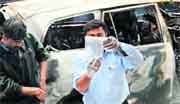 Special Investigators examine a vehicle that exploded near the Israeli embassy in New Delhi