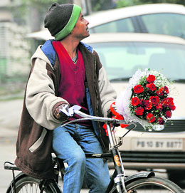 A delivery boy searches for the address to hand over a bouquet on Valentine’s Day in Ludhiana.