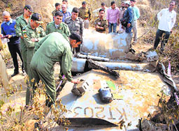 IAF officials check the debris of Mirage 2000 that crashed in Bhind (Madhya Pradesh) on Friday.