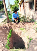 The pitsA man shows an uncovered manhole in Sector 15, Panchkula