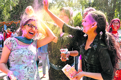Girls throw gulal at each other while celebrating Holi at MCM DAV College at Sector 36 in Chandigarh on Friday.