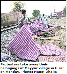Protesters take away their belongings at Mayyar village in Hisar on Monday. 