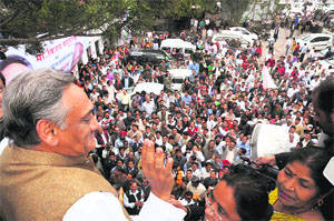 Chief Minister Vijay Bahuguna greets supporters at Congress Bhavan in Dehradun on Wednesday. 