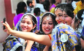 Girls click their picture during a farewell party for BCA III students at the Government College for Women in Ludhiana