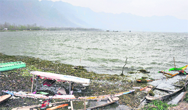 Shikaras and boats damaged by Tuesdays gusty winds on the banks of the Dal Lake in Srinagar. 
