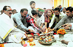 Cabinet Minister Mantri Prasad Naithani (wearing a cap) performs a yajna in his office in Dehradun on Friday