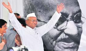 ON FAST TRACK: Anti-corruption activist Anna Hazare waves to his supporters during his daylong fast against corruption near Parliament House in New Delhi on Sunday