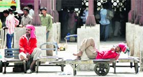Porters sit idle at the railway station in Ludhiana