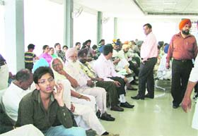 Visitors wait for their turn at the Office of Sub-Registrar in Ludhiana on Thursday