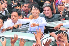 Suu Kyi leaves the National League for Democracy headquarters in Yangon on Monday